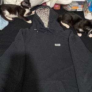 Black hoodie with cheetah print hood.